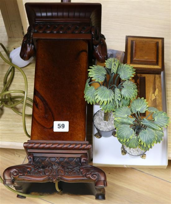 A pair of palm tree ornaments, three boxes and a lamp